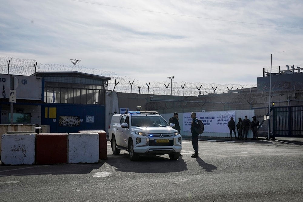Israeli soldiers stand outside the Ofer military prison near occupied al-Quds, occupied Palestine, on Saturday, January 25, 2025 (AP)