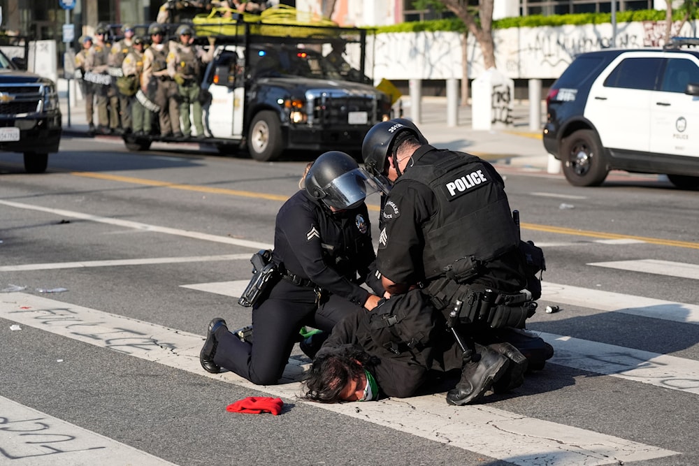 A Los Angeles police officers arrest a protester in downtown Los Angeles on Monday, June 9, 2025. (AP Photo Jae Hong)