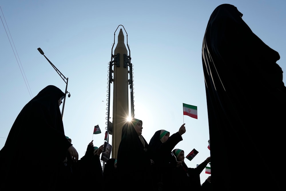 Members of the Iranian Basij paramilitary force march as a domestically-built missile is displayed during the force parade in Tehran, Iran, Friday, Jan. 10, 2025. (AP)