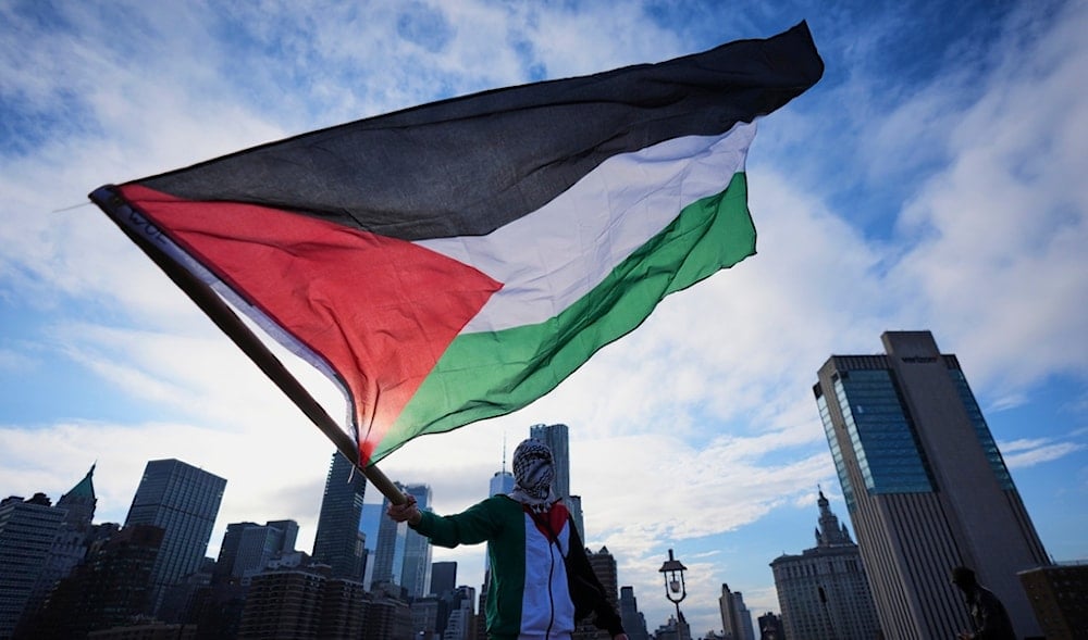 A Pro-Palestinian demonstrator waves a flag on the Brooklyn Bridge during a march Thursday, May 15, 2025, in New York. (AP)