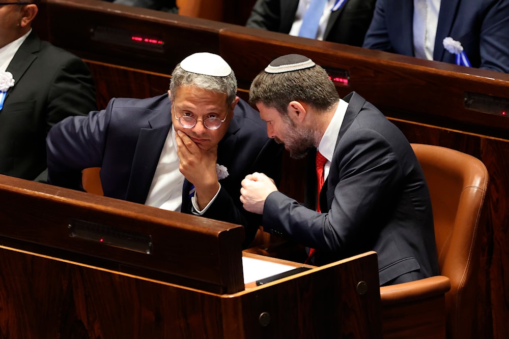 Israeli right wing Knesset member Itamar Ben Gvir, left, and Bezalel Smotrich, right, talk with each other during the swearing-in ceremony for Israeli lawmakers at the Knesset, Israel's parliament, in al-Quds, Tuesday, Nov. 15, 2022. (AP)