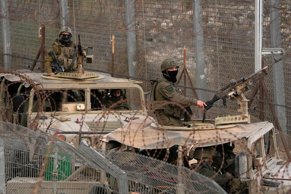 Israeli soldiers stand on armored vehicles after crossing the security fence near the so-called Alpha Line that separates the Israeli-occupied Golan Heights from Syria, in the town of Majdal Shams, Dec. 21, 2024 (AP)