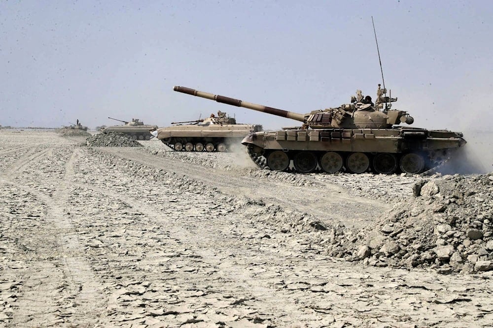 In this photo provided Saturday, Feb. 22, 2025, by the Iranian Army, tanks move forward during a drill in southeastern Iran. (Iranian Army via AP)