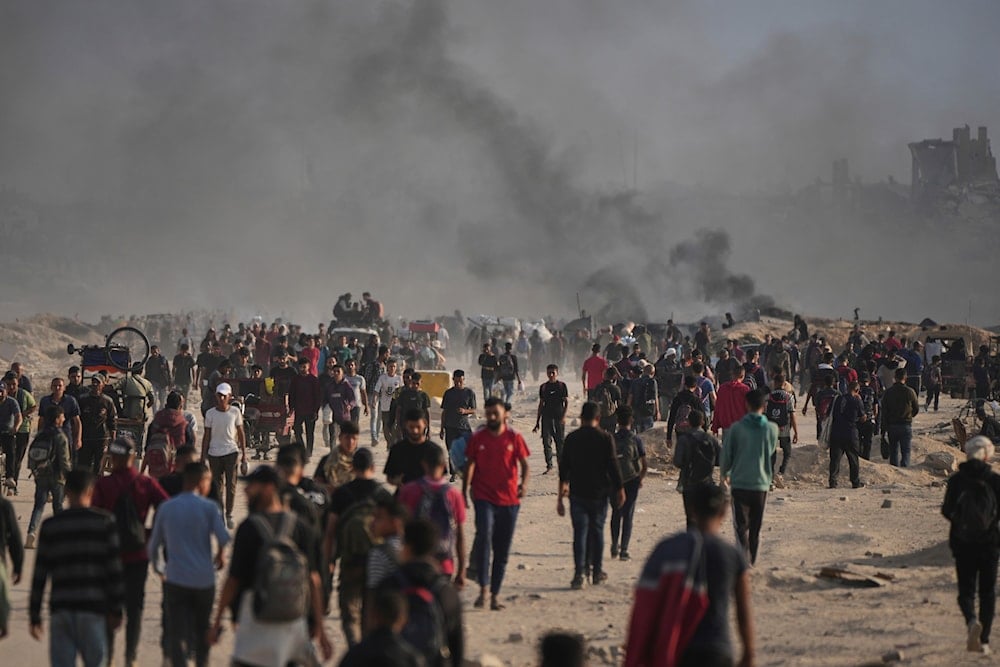 Forcibly displaced Palestinians move along the shore of Gaza city on Monday, June 9, 2025. (AP)