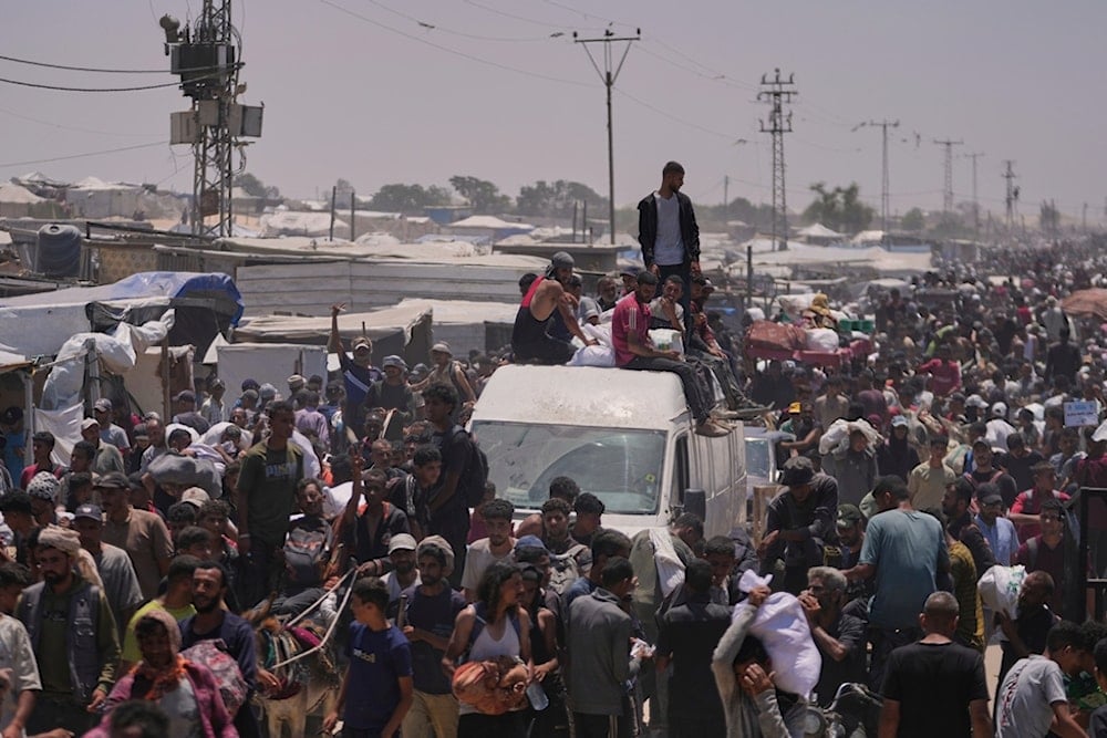 Palestinians carry bags containing food and humanitarian aid packages delivered by the Gaza Humanitarian Foundation, a US-backed organization, in Rafah, southern Gaza Strip, Wednesday, June 11, 2025 (AP)
