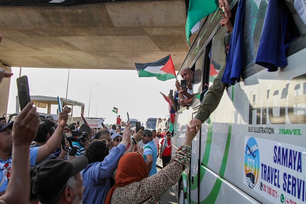 People cheer as a convoy of buses made up of activists, lawyers and medical professionals from North Africa depart from Tunisia to Gaza to break Israel's blockade on the territory, in Gabes, Tunisia, Monday, June 9, 2025 (AP)