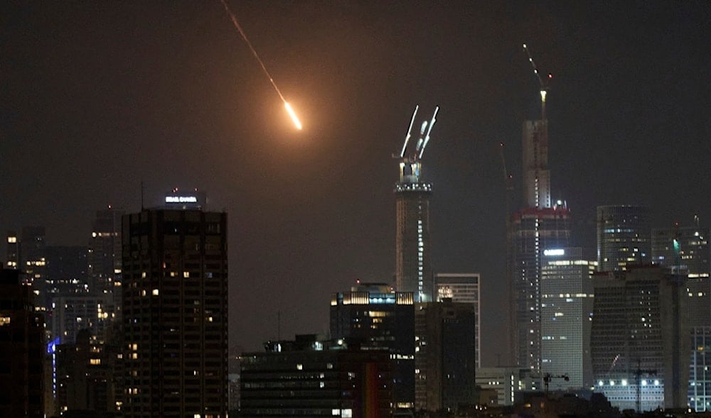 The trace of a projectile is seen before hitting Tel Aviv, occupied Palestine, early Saturday, June 14, 2025. (AP)