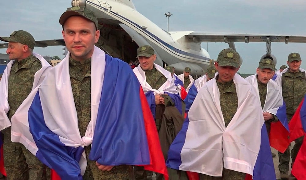 In this photo, taken from a video released by Russian Defense Ministry Press Service on June 12, 2025, servicemeN walk from a plane as they return from a prisoner of war exchange between Russia and Ukraine, at an airport outside Moscow. (AP)