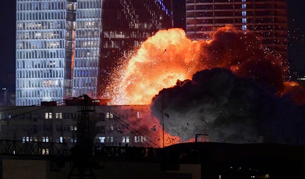 An explosion after an Iranian missile makes impact in Tel Aviv, occupied Palestine, Friday, June 13, 2025. (AP)