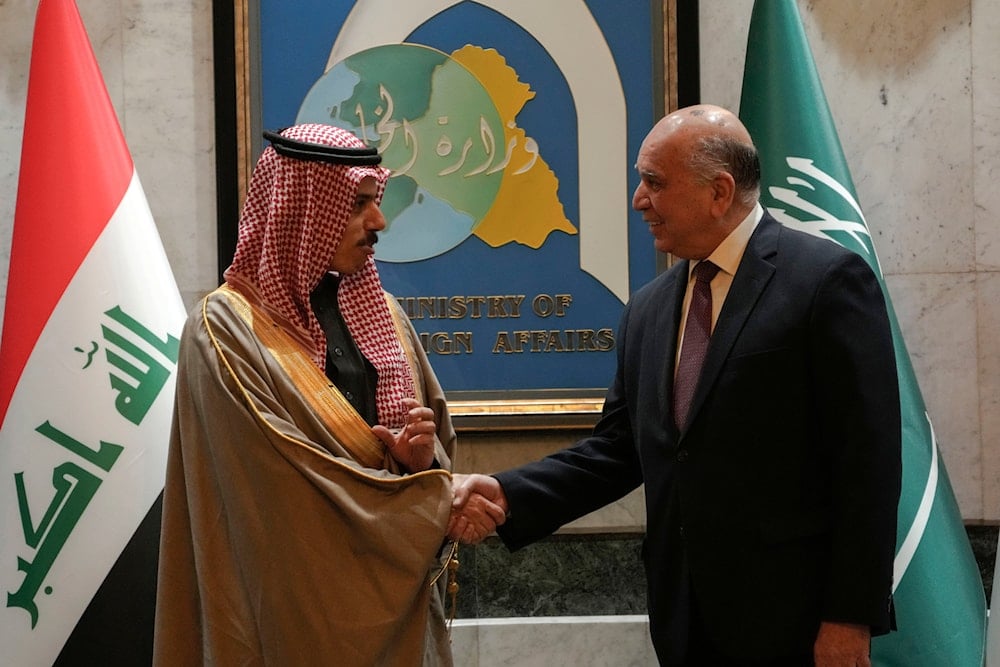 Iraqi Foreign Minister Fouad Hussein, right, shakes hands with Saudi Foreign Minister Prince Faisal Bin Farhan Al Saud before their talk in Baghdad, Iraq, Thursday, Feb. 2, 2023 (AP)