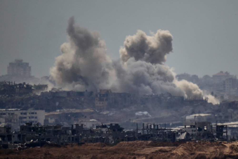 Smoke rises to the sky after an explosion in the Gaza Strip as seen from the Occupied Palestinian Territories, Thursday, May 22, 2025 (AP)