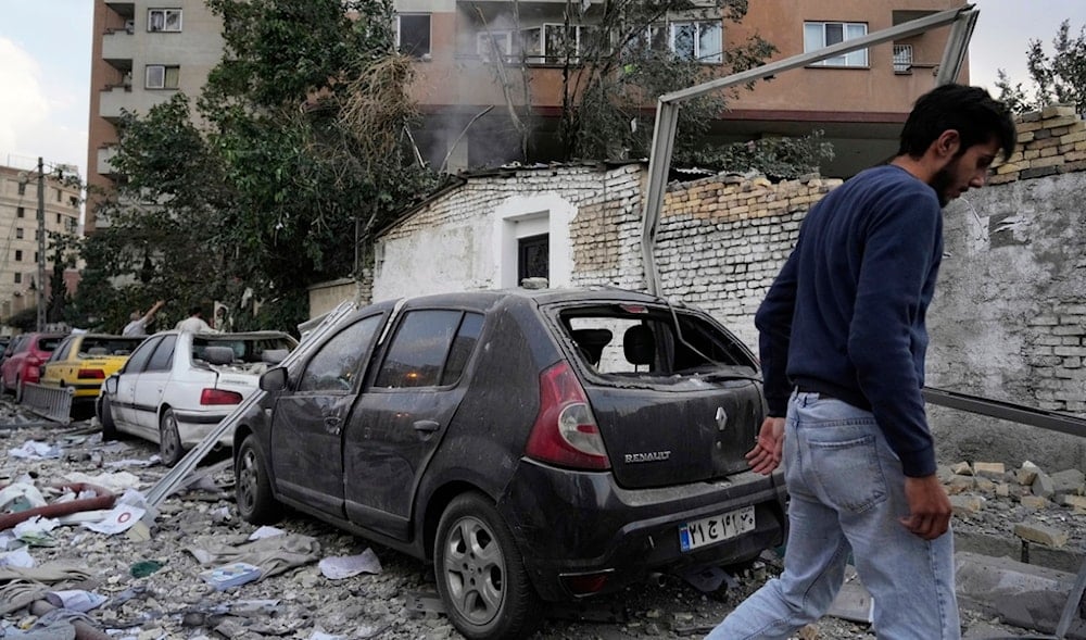 A man walks at the scene of an Israeli strike in a residence compound in northern Tehran, Iran, Friday, June 13, 2025. (AP)