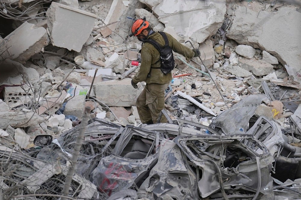 An Israeli soldier navigates the rubble of a residential building that was hit by a missile fired from Iran, near Tel Aviv, Palestine, Sunday, June 15, 2025.(AP Photo/Ariel Schalit)