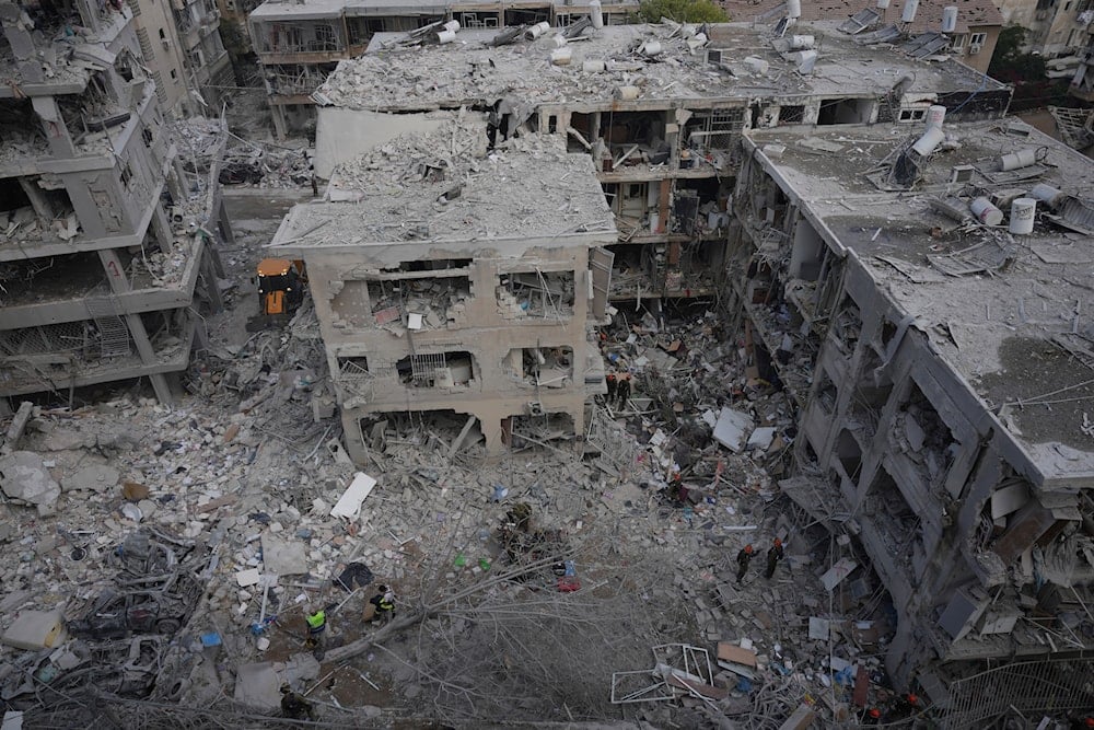 Israeli first responders work in a residential area hit by a missile fired from Iran, near Tel Aviv, Israel, Sunday, June 15, 2025.(AP Photo/Ariel Schalit)