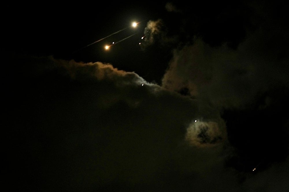 Traces of projectiles illuminate the clouds, as seen from northern occupied Palestine, Saturday, June 14, 2025 (AP)