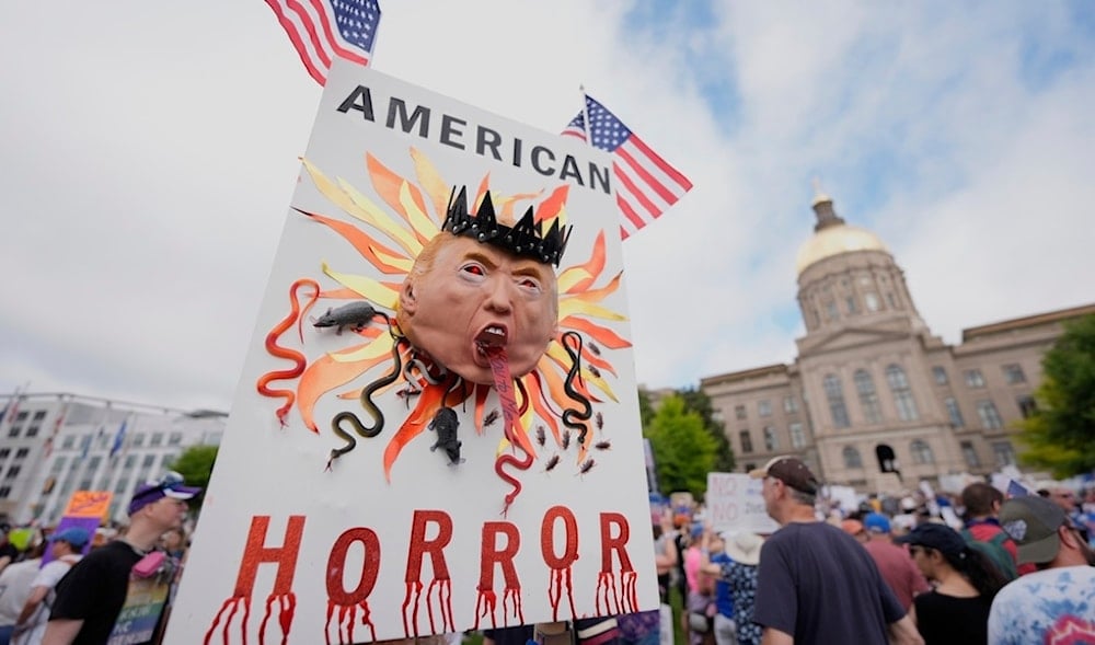 A demonstrator holds a sign during a 