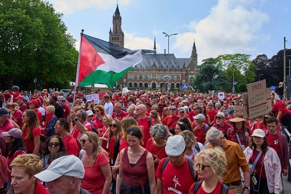 Tens of thousands of red-clad protesters marched past the Peace Palace demanding their government do more to halt 'Israel's' war on Gaza, during a demonstration in The Hague, Netherlands, Sunday, June 15 (AP)