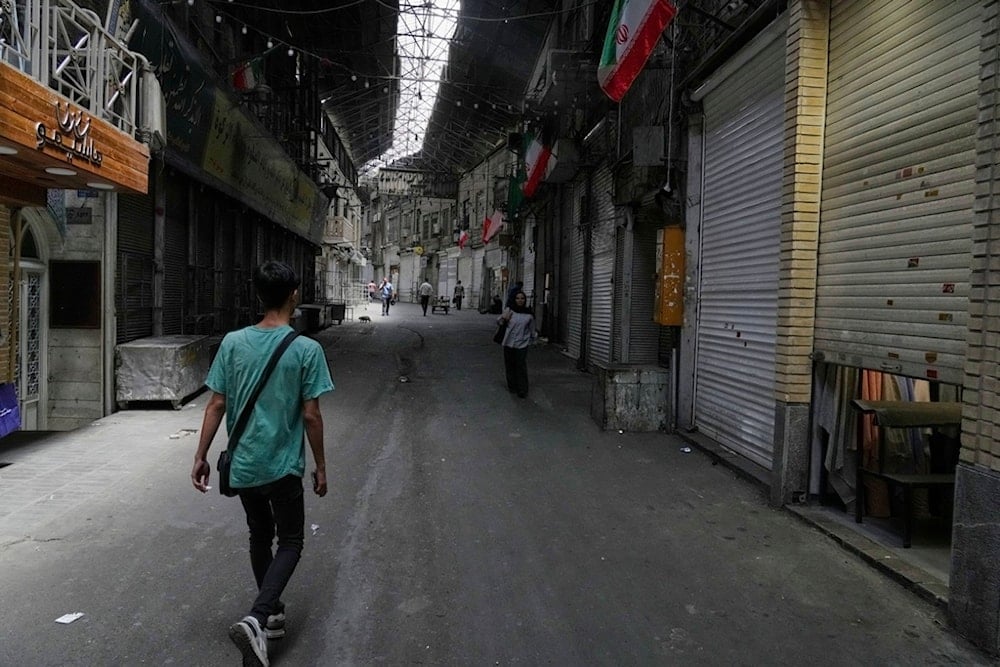 Few pedestrians walk along the historic Grand Bazaar as shops remain shuttered, in Tehran, Iran, Monday, June 16, 2025 (AP)