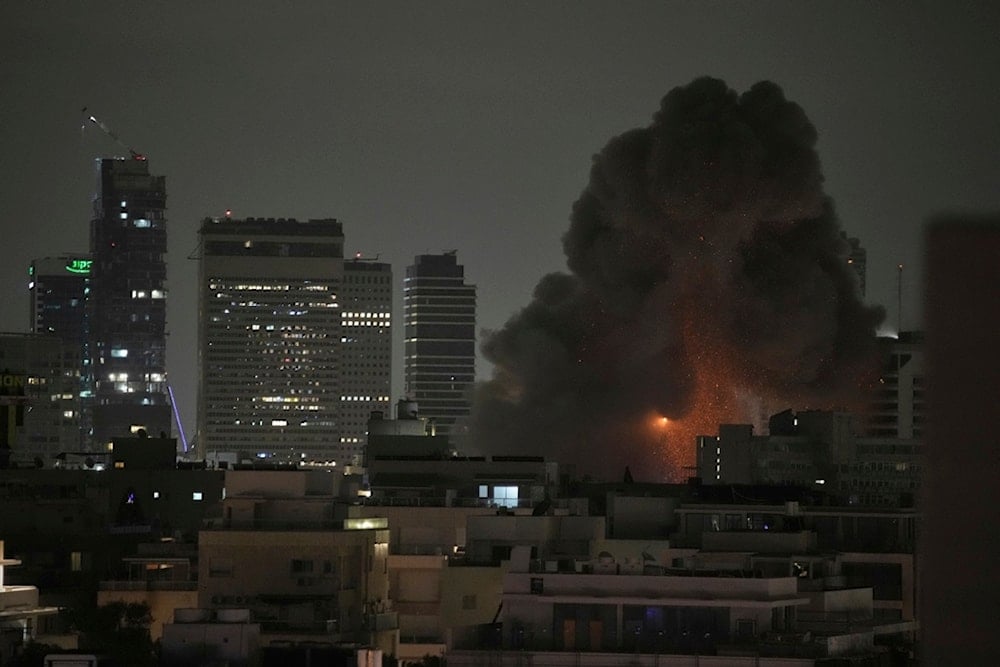 An explosion is seen after an Iranian missile struck Tel Aviv, occupied Palestine, Monday, June 16, 2025 (AP)