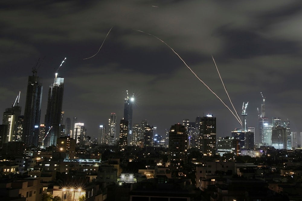 The Israeli Iron Dome air defense system fires to intercept missiles over Tel Aviv, occupied Palestine, Sunday, June 15, 2025 (AP)
