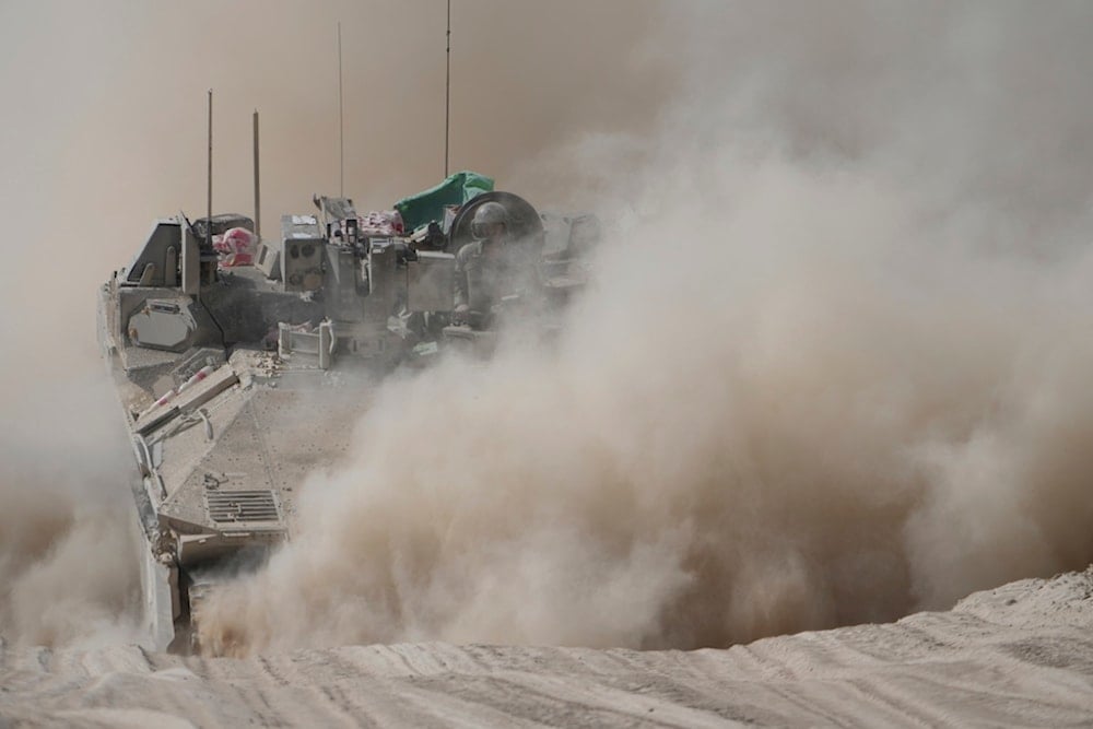 An Israeli army armored personnel carrier maneuvers near the Gaza envelope, southern occupied Palestine, Wednesday, June 11, 2025 (AP)