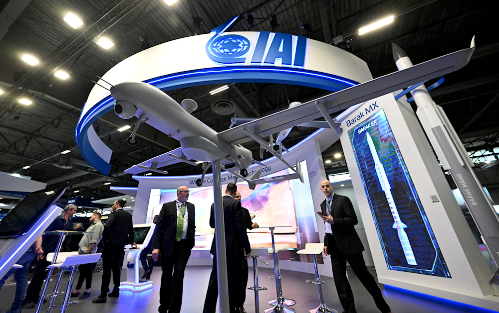 Visitors stand at the Israel Aerospace Industries (IAI) booth at the Eurosatory international land and air defense and security trade fair, in Villepinte, a northern suburb of Paris, on June 13, 2022 (Emmanuel Dunand/AFP)
