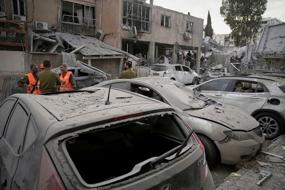 Damaged cars are seen at the site where an Iranian missile struck in Bnei Brak, near Tel Aviv, occupied Palestine, Monday, June 16, 2025 (AP)