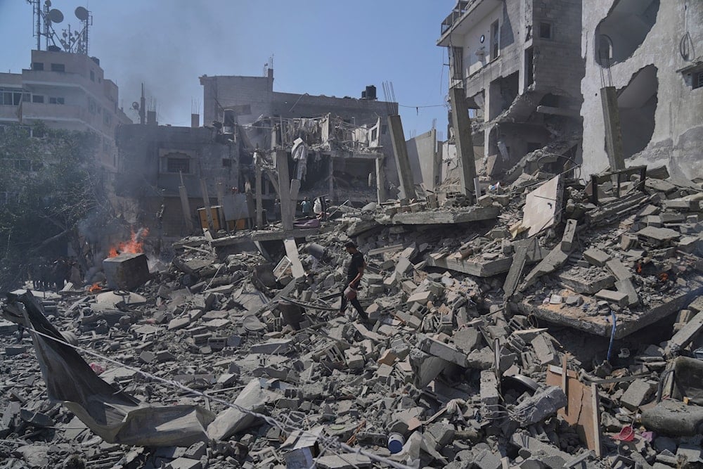 A Palestinian man walks across the rubble of a building destroyed by an Israeli strike in Deir al-Balah, central Gaza Strip, Monday, June 16, 2025. (AP)