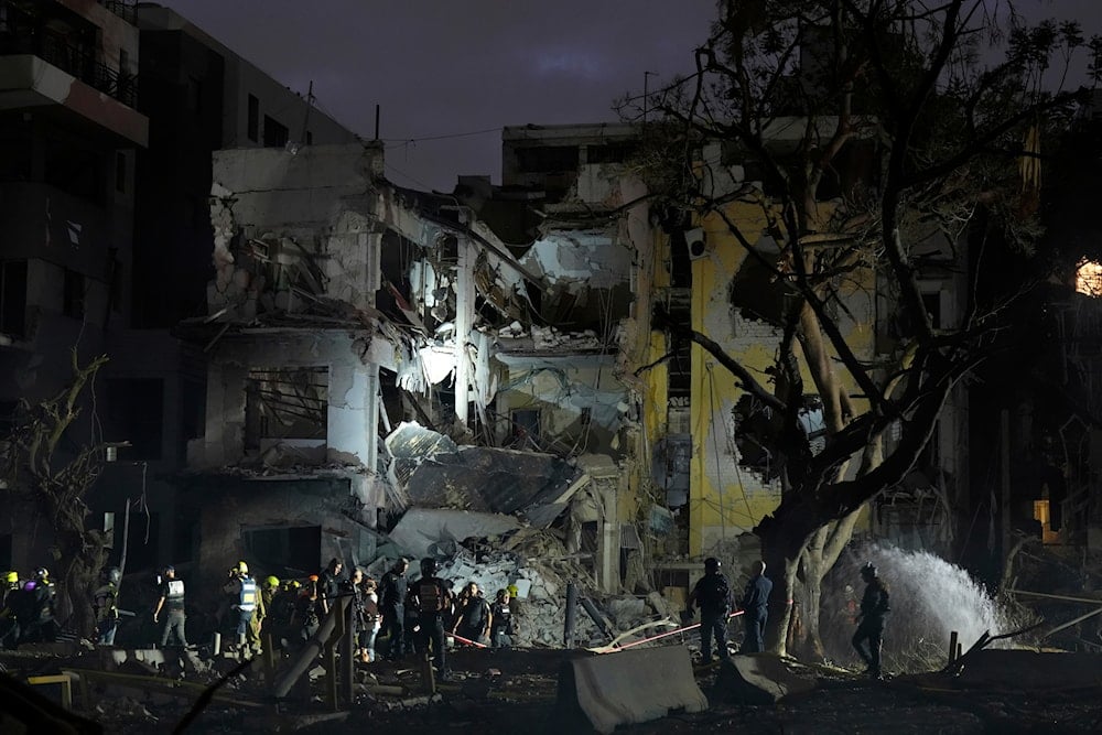 Rescue team work at the site where a missile launched from Iran struck Tel Aviv, Israel, Monday, June 16, 2025 (AP)