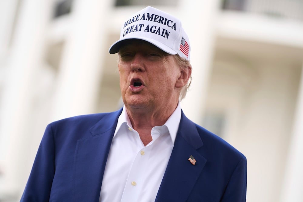 US President Donald Trump talks with reporters before a flag pole is installed on the South Lawn of the White House, Wednesday, June 18, 2025, in Washington. (AP)