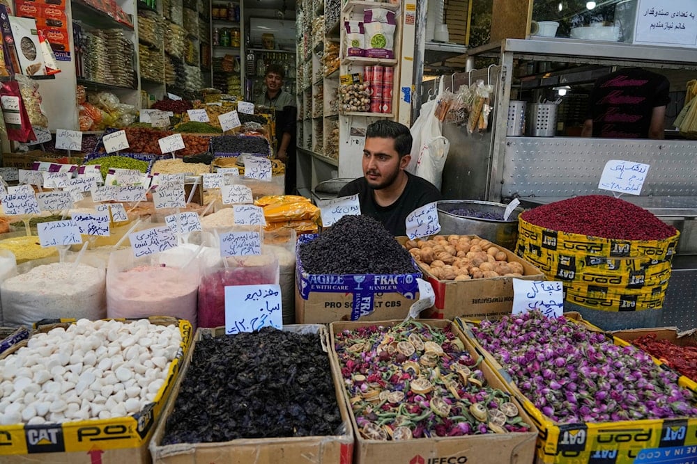 A shopkeeper waits for customers at the historic Grand Bazaar in Tehran, Iran, Monday, June 16, 2025 despite the ongoing Israeli aggression. (AP)