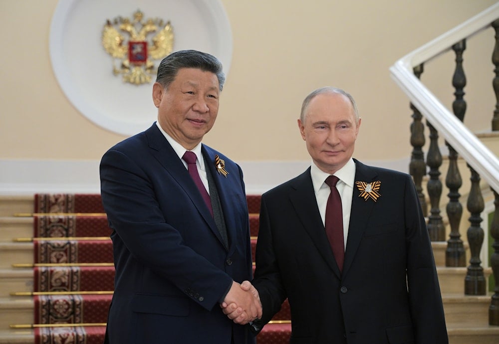 Chinese President Xi Jinping, left, and Russian President Vladimir Putin shake hands during their meeting before the Victory Day military parade in Moscow, Russia, Friday, May 9, 2025. (Alexei Nikolsky/Photo host agency RIA Novosti via AP)