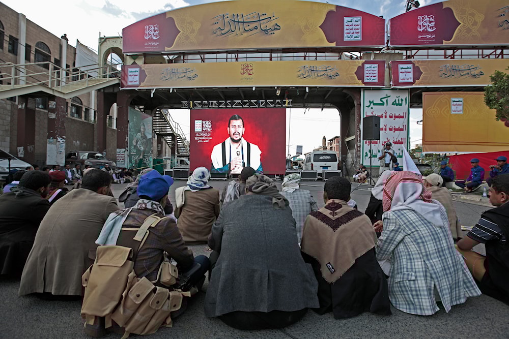 Supporters of Sayyed Abdul-Malik al-Houthi, leader of Yemen’s Ansar Allah movement, watch his speech shown on a screen in Sanaa, Yemen, Thursday, Aug. 19, 2021. (AP)