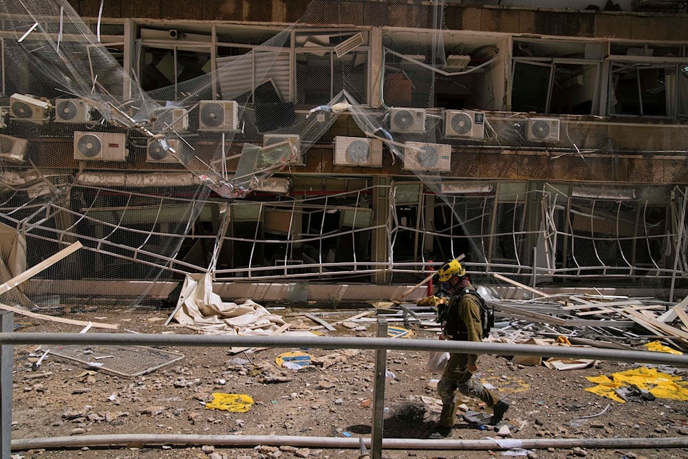 A firefighter walks past a damaged area at the Soroka hospital complex after it was hit by a missile fired from Iran in Beersheba, Occupied Palestine, Thursday, June 19, 2025 (AP)