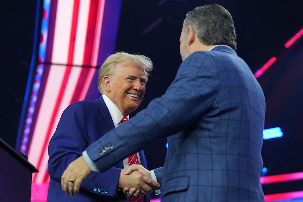 President-elect Donald Trump speaks with United States Senator Ted Cruz at AmericaFest, Sunday, Dec. 22, 2024, in Phoenix. (AP Photo/Rick Scuteri)