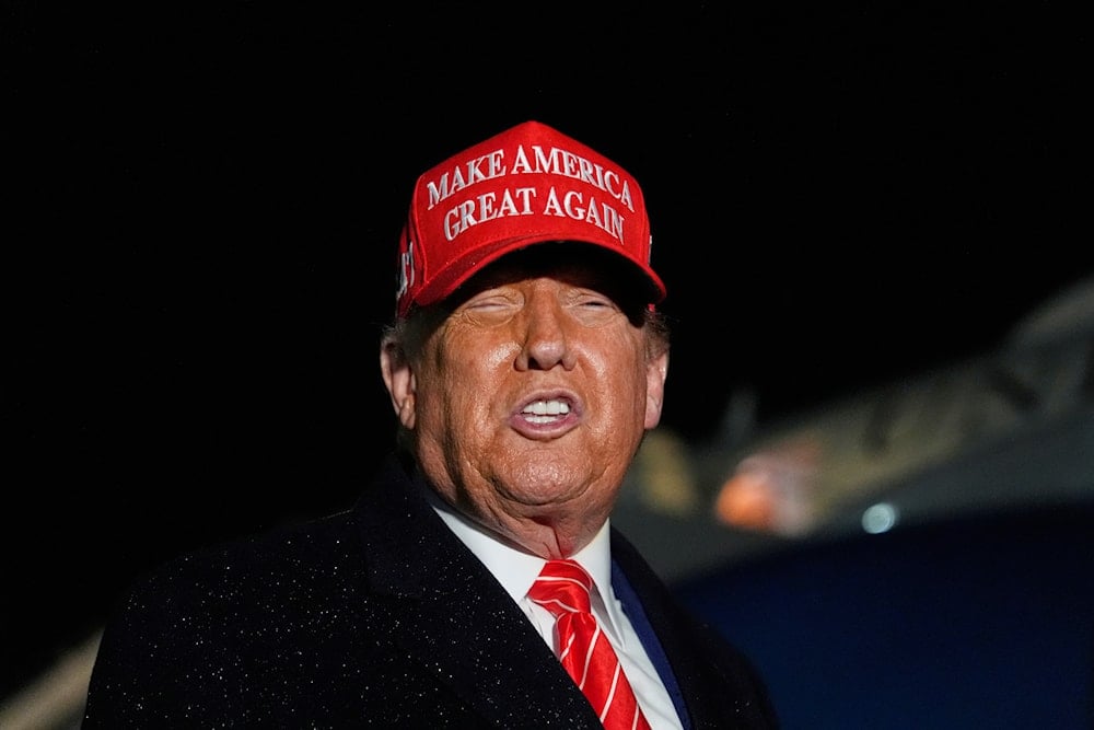 President Donald Trump speaks to reporters in the rain after arriving on Air Force One at Joint Base Andrews, Md., Friday, May 30, 2025 (AP)