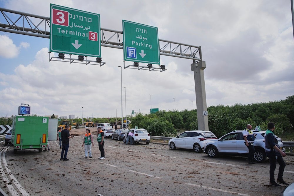 Israeli security forces inspect the site where the Israeli military said a projectile fired by Yemen's Houthi rebels landed in the area of Ben Gurion International Airport near Tel Aviv, Israel, on May 4, 2025. (AP Photo/Ohad Zwigenberg)