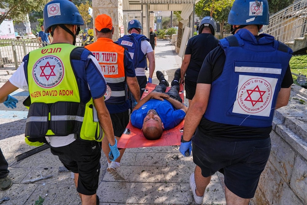 A man is evacuated by an Israeli emergency team after a missile from Iran hits in Haifa, Israel, Friday, June 20, 2025 (AP)