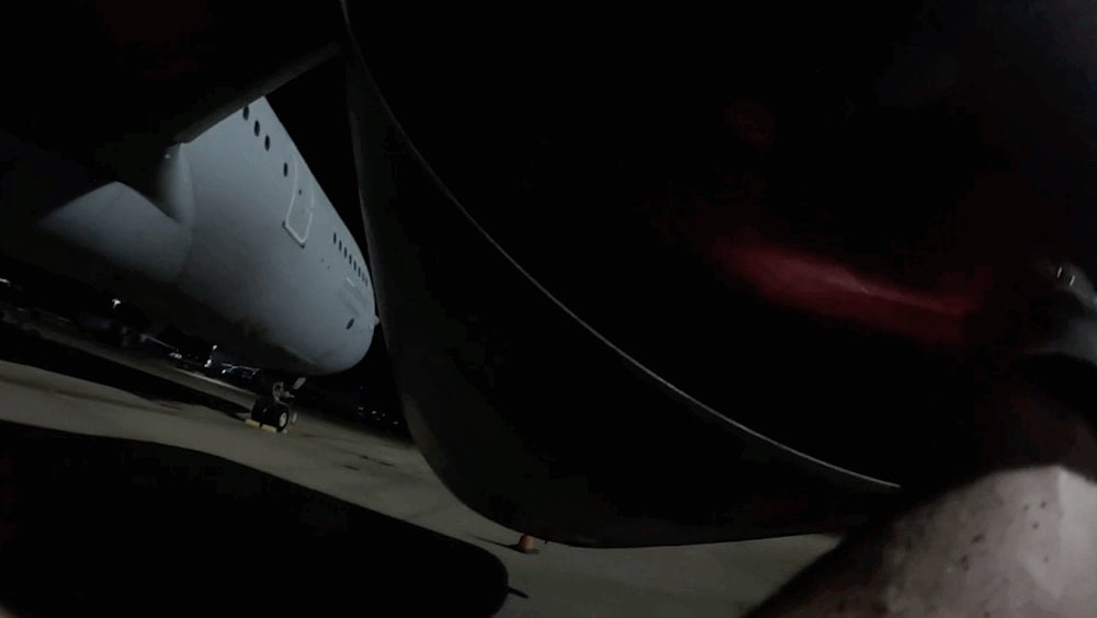 Screengrab shows a pro-Palestine activist approaching an RAF aircraft during the sabotage operation. (Palestine Action)
