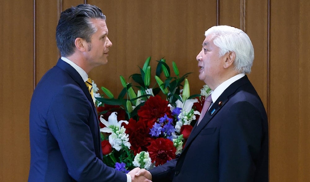 Japan's Defense Minister Gen Nakatani, right, and U.S. Secretary of Defense Pete Hegseth shake hands during a joint news conference at the Ministry of Defense in Tokyo Sunday, March 30, 2025. (AP)