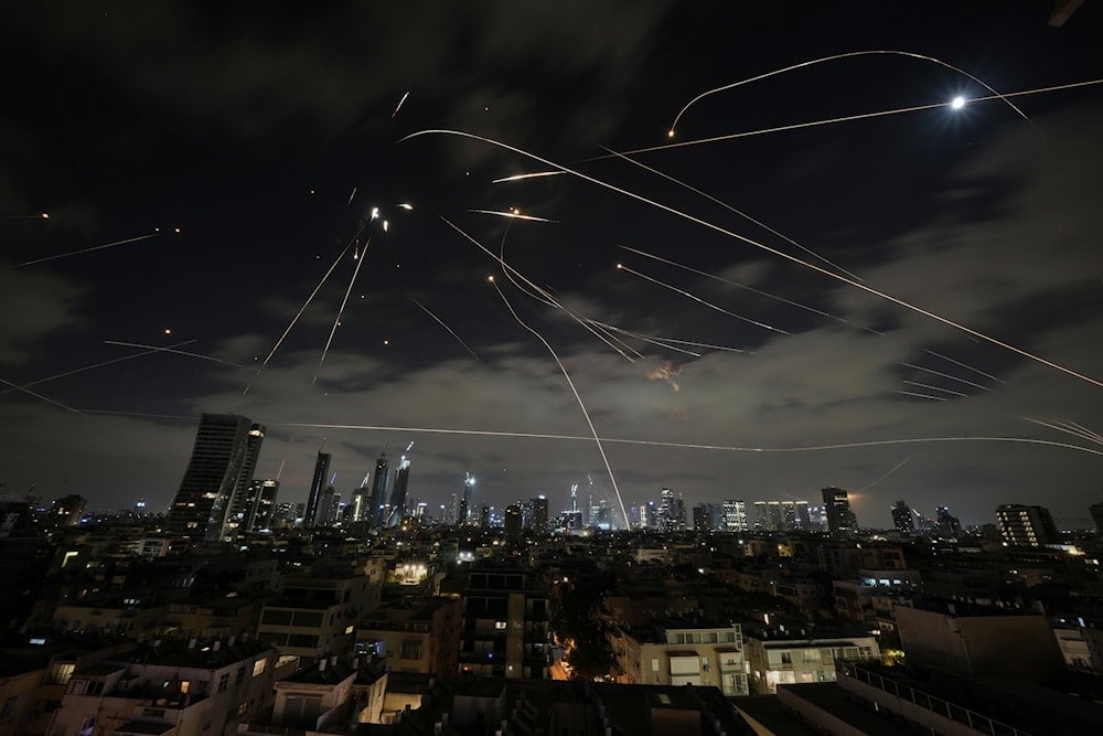 The Israeli Iron Dome air defense system fires to intercept missiles during an Iranian attack over Tel Aviv, Occupied Palestine, Sunday, June 15, 2025 (AP)