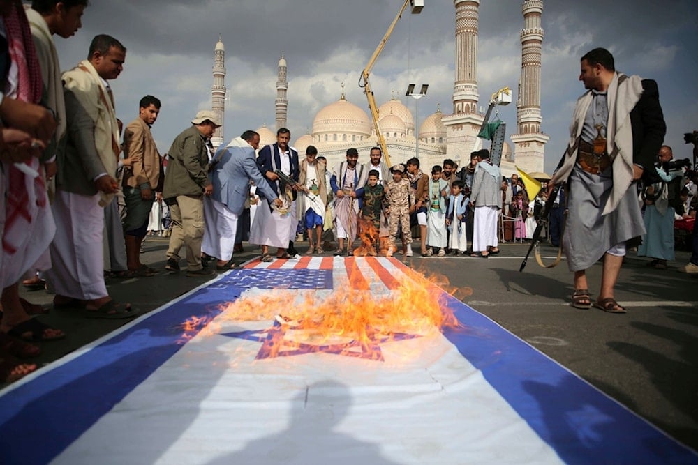Yemenis burn US and Israeli flags during an anti-US and anti-Israeli weekly rally in Sanaa, Yemen, Friday, June 20, 2025 (AP)