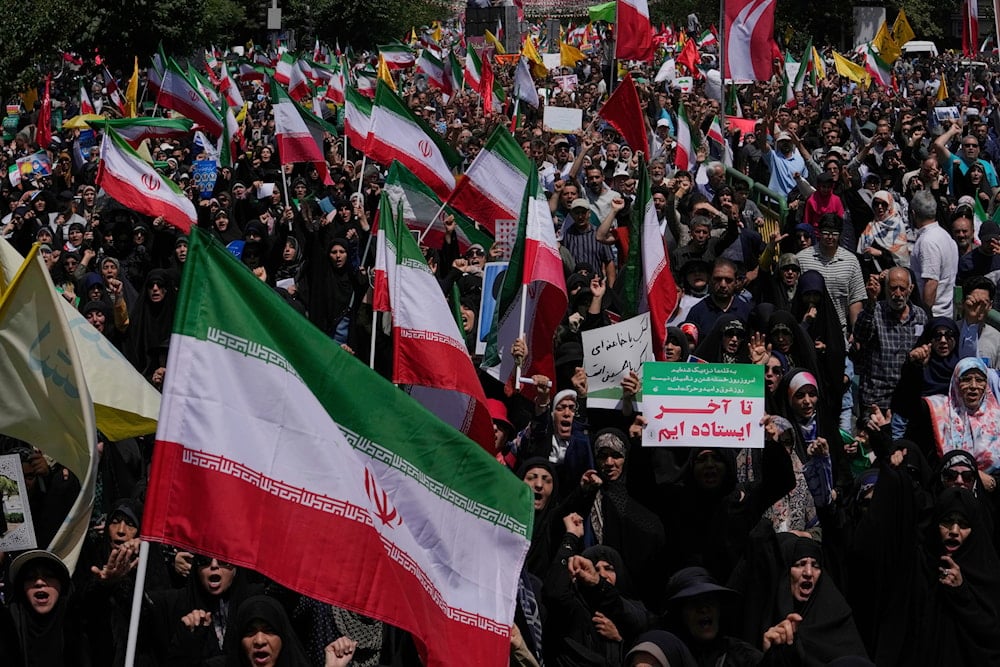 Iranian worshippers carry their country's flags in a protest to condemn Israeli attacks on multiple cities across Iran, after the Friday prayers ceremony in Tehran, Iran, Friday, June 20, 2025. (AP)