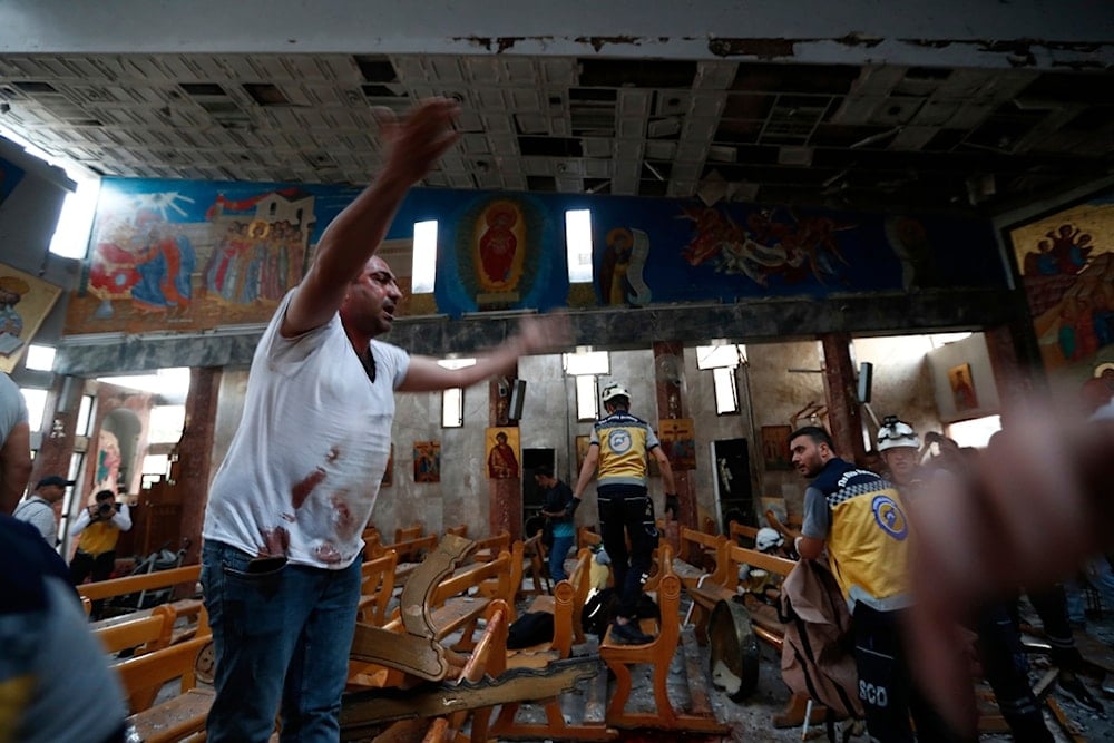 A Syrian man reacts inside Mar Elias church where a suicide bomber detonated himself in al-Dweila on the outskirts of Damascus, Syria, Sunday, June 22, 2025 (AP)