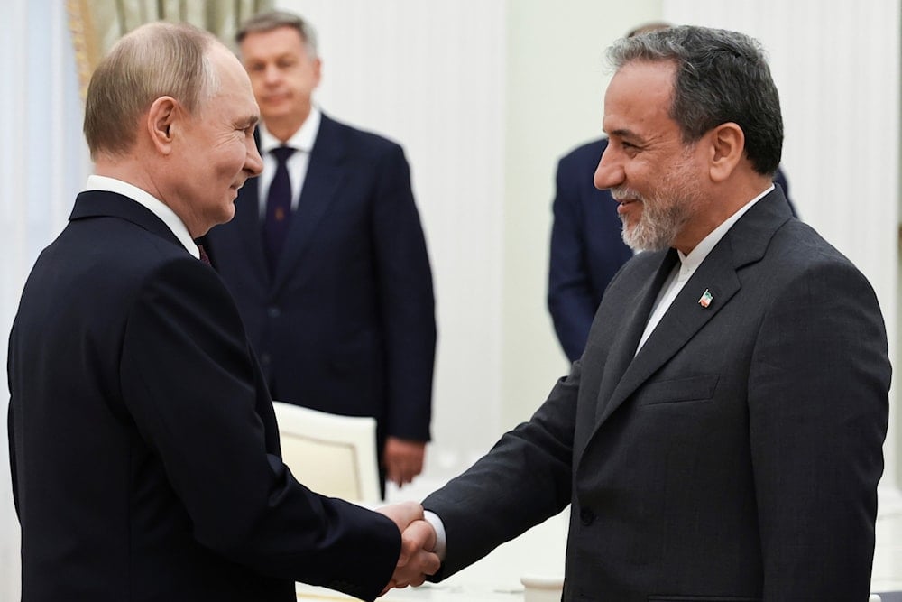 Russian President Vladimir Putin, left, greets Iranian Foreign Minister Abbas Araghchi prior to their talks at the Kremlin in Moscow, Russia, Monday, June 23, 2025. (AP)