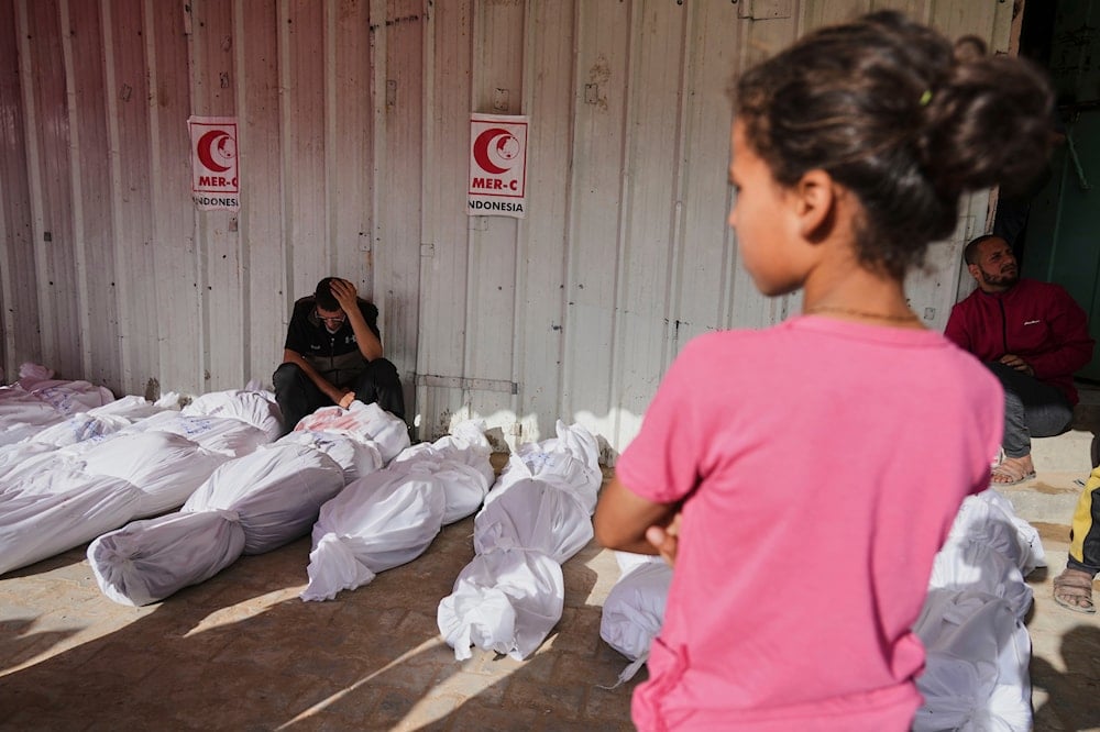 Palestinian child mourn her family killed in an Israeli airstrikes in Jabalia, northern Gaza Strip, on Wednesday, May 14, 2025. (AP Photo/Jehad Alshrafi)