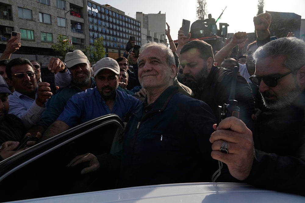Iranian President Masoud Pezeshkian, center, gets into his car after attending a protest following the US attacks on nuclear sites in Iran, in Tehran, Iran, Sunday, June 22, 2025 (AP)