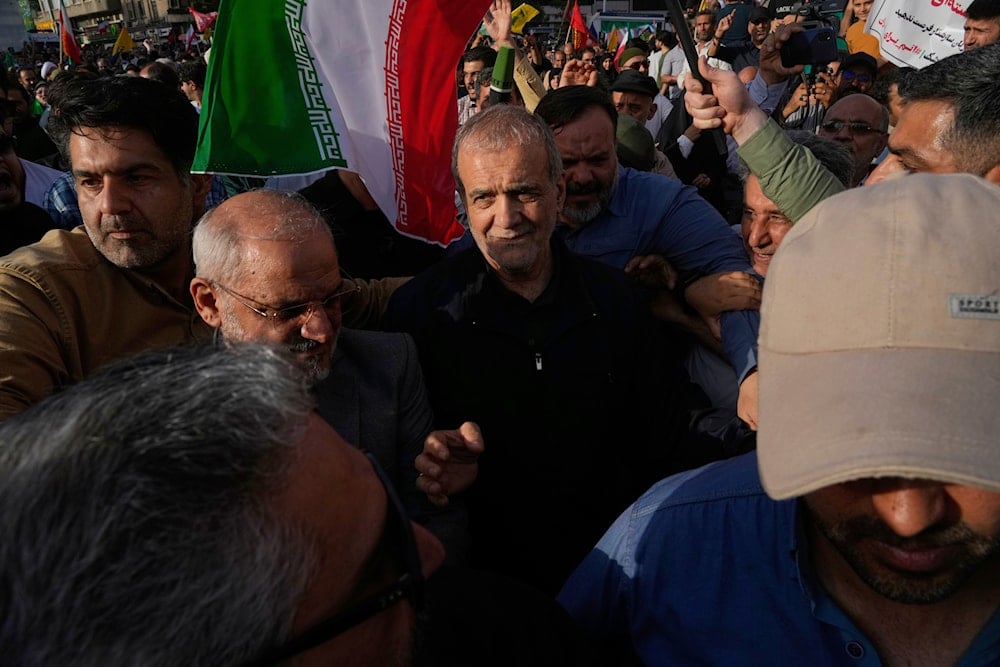 Iranian President Masoud Pezeshkian, center, attends a protest following the US attacks on nuclear sites in Iran, in Tehran, Iran, Sunday, June 22, 2025 (AP)