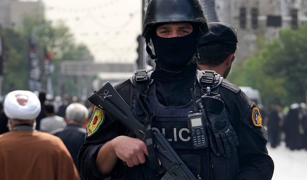 An Iranian police officer stands guard during the funeral ceremony of Hamas leader Ismail Haniyeh and his bodyguard, at Azadi (Freedom) St. in Tehran, Iran, Thursday, Aug. 1, 2024. (AP)