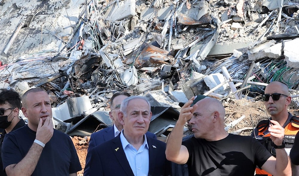 Israeli Prime Minister Benjamin Netanyahu visits the site of the Weizmann Institute of Science, which was hit by missiles fired from Iran, in the central city of Rehovot on Friday, June 20, 2025. (Jack Guez/Pool Photo via AP)